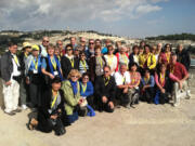 This picture of parishioners from Our Lady of Lourdes Catholic Church was taken before hostilities broke out. The group was in Jerusalem just finishing up a 12-day tour of Israel; that's the Mount of Olives behind them. Front row middle is Rev. Michael Radermacher, and Sue McDonald is far right in black vest and salmon shirt.