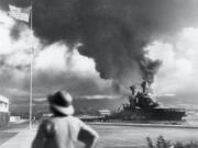 American ships burn during the Japanese attack on Pearl Harbor, Hawaii, on Dec.