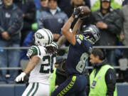 Seattle Seahawks' Golden Tate, right, makes a catch for a touchdown over New York Jets' Kyle Wilson in the first half of an NFL football game, Sunday, Nov. 11, 2012, in Seattle.