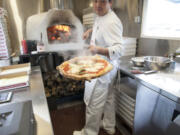 Daisuke Matsumoto cooks Neapolitan-style pizza pies in roughly 90 seconds in the wood-fire oven he installed in his food truck, Pizzeria La Sorrentina, with a friend’s help.