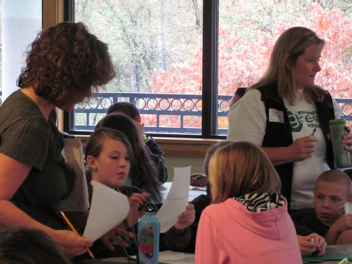 Grass Valley Elementary teachers Julie Della-Valle (left) and JeanSchroeder work with students on a &quot;share your story,&quot; activity.