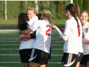 Camas High School goalkeeper Lauren Rood celebrates with her teammates after blocking three kicks by Mead in the shootout Saturday, at Doc Harris Stadium.