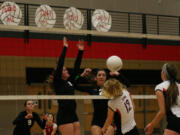 Camas seniors Abbie Younkin (11) and Lauren Neff (2) dunked the volleyball on a Union Titan.