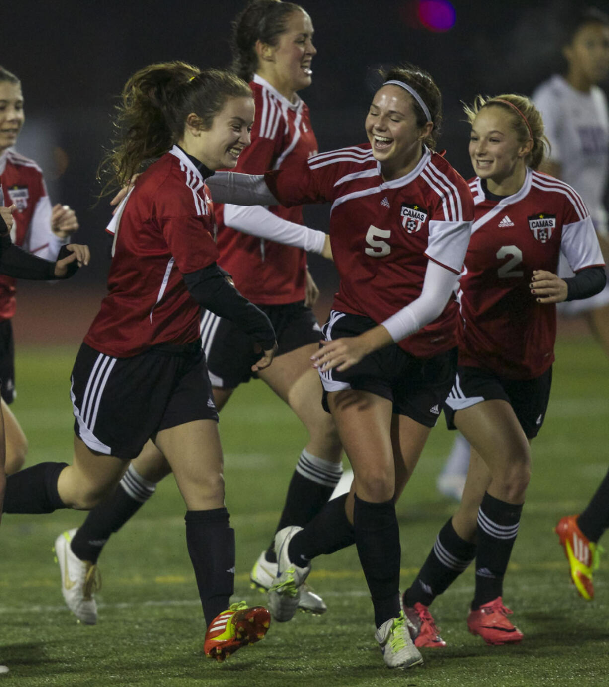 Camas High School's Teylen Sheesley, left, celebrates scoring a goal against Issaquah High School with teammates Rachel Gibson, center, and Makaela Norrish during a playoff game at Sparks Stadium in Puyallup Wash., Friday Nov. 16, 2012.