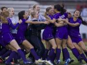 The Columbia River girls soccer team celebrates a 3A state semfiinal win over Liberty on penalty kicks.