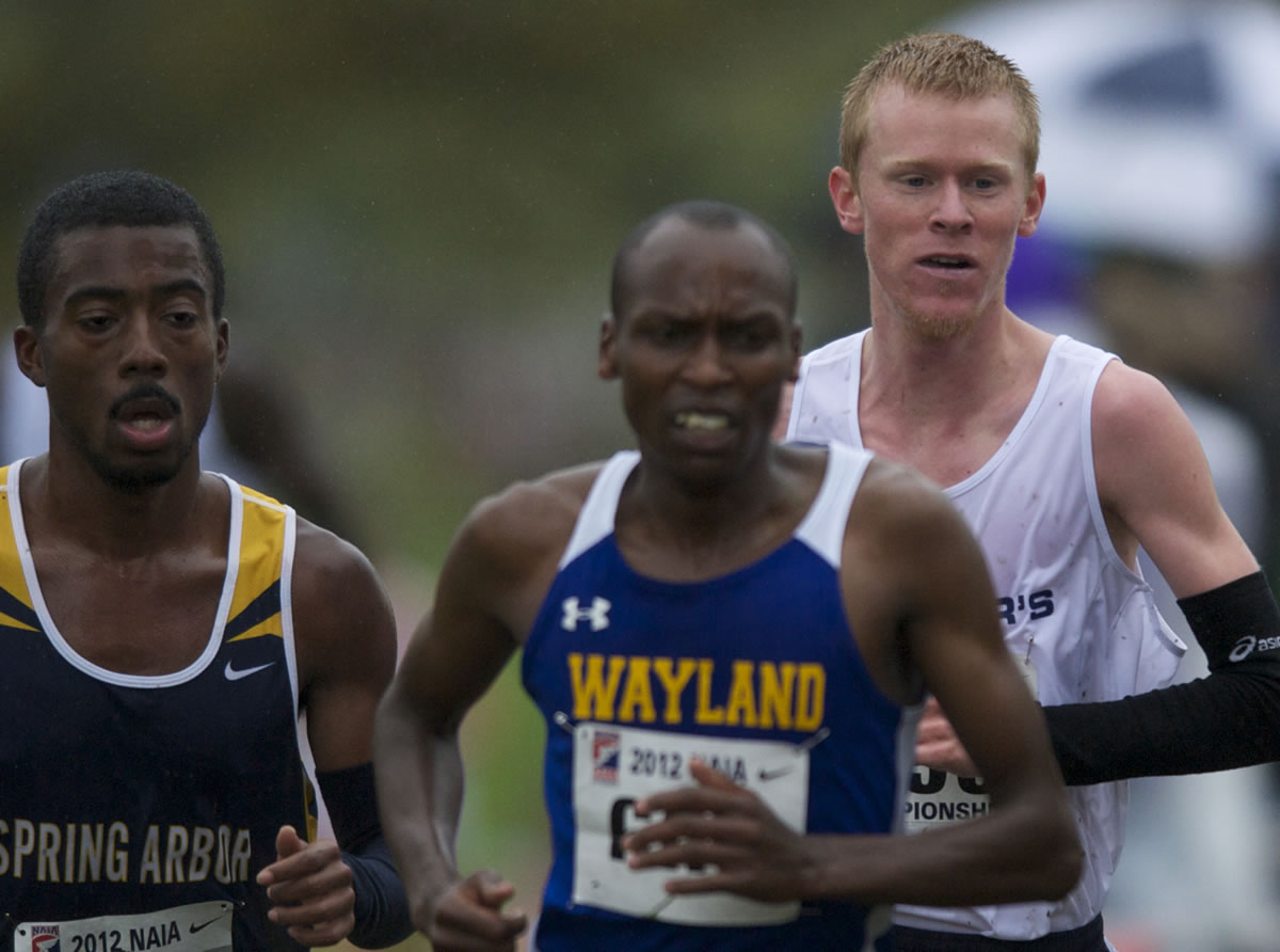 John Gilbertson, right, from The Master's College, goes on to win the NAIA cross country national championship race at Fort Vancouver on Saturday November 17, 2012.