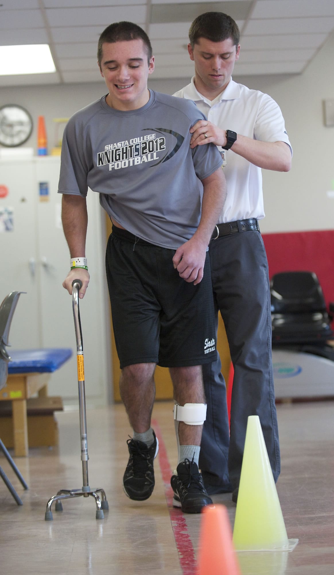 Tyler Burton, who suffered a traumatic brain injury after being assaulted last year, works with his physical therapist, Tim Hughes, at PeaceHealth Southwest Medical Center on Monday. Burton will be discharged from the hospital's inpatient rehabilitation center in the coming days.