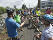 Photos by Steven Lane/The Columbian
Todd Bachmann of the Arnada Neighborhood Association, left, leads a tour of a new section of trail along Lower River Road on Friday. The tour was aimed at highlighting the delights -- and dangers -- of cycling from downtown to Vancouver  Lake.