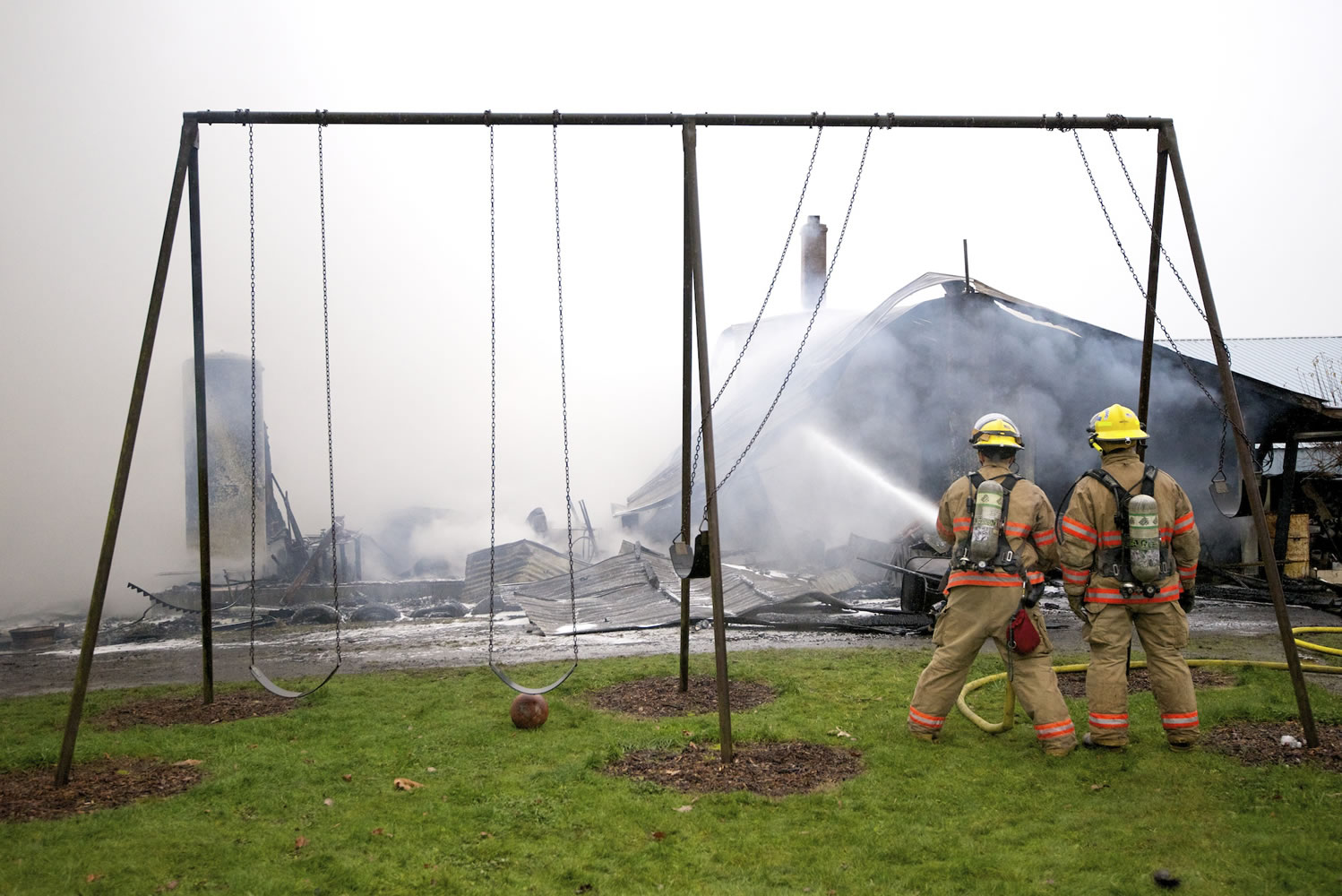 Firefighters work Wednesday morning to contain a fire that destroyed a shop owned by John and Delores Matson of Brush Prairie.