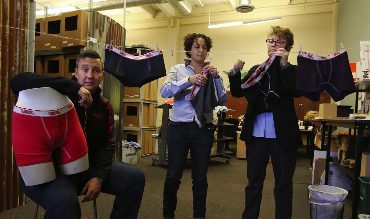 Seattle detective Carma Clark, left, helps with the design of the pants on the form. Naomi Gonzalez, center, and Fran Dunaway, right, co-founded the clothing company called TomboyX that specializes in making boxer briefs for women.