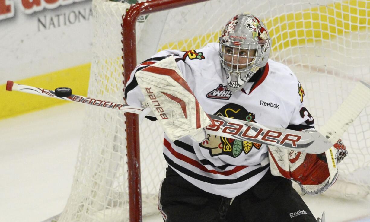 Portland Winterhawks goaltender Mac Carruth gets his stick on a Kamloops shot in a 4-1 win Friday.