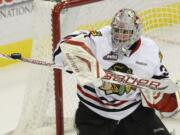 Portland Winterhawks goaltender Mac Carruth gets his stick on a Kamloops shot in a 4-1 win Friday.