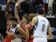 Minnesota Timberwolves center Karl-Anthony Towns (32) holds onto the ball against Portland Trail Blazers center Ed Davis (17) and forward Meyers Leonard (11) during the fourth quarter of an NBA basketball game on Saturday, Dec. 5, 2015, in Minneapolis. The Trail Blazers won 109-103.