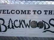 A sign hangs on the fence surrounding Backwoods Brewing's patio in Carson. The three-year-old brewery in the Columbia River Gorge is expanding so rapidly that production is moving to the Port of Skamania in Stevenson.