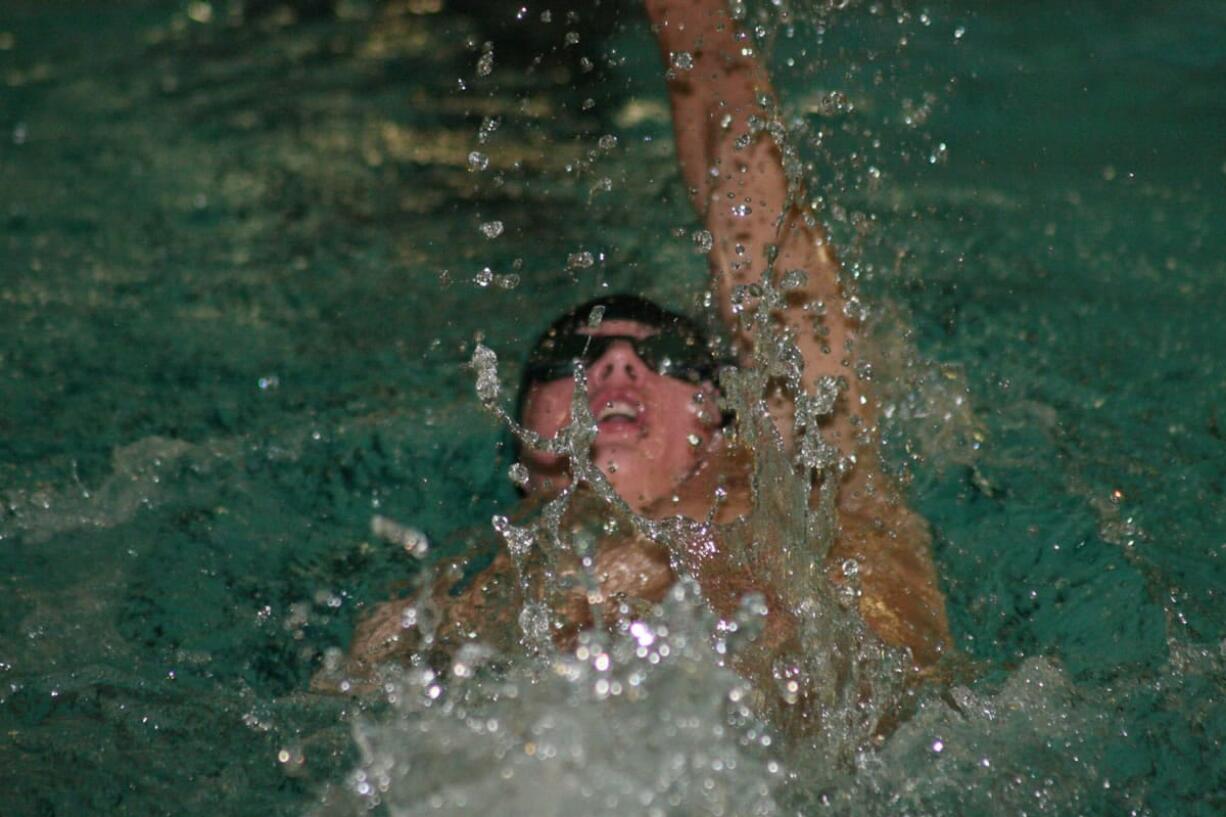 Lucas Ulmer leaves a trail of water droplets in his wake while swimming the 100-meter backstroke for Camas Thursday, at David Douglas High School in Portland, Ore.