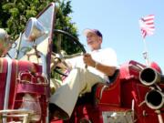 Dick Streissguth drives his 1929 Mack fire engine in 2000. He owned a dozen fire engines in various states of restoration.