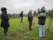 Opponents of a land sale near the East Fork of the Lewis River look over the property recently. The Clark County council voted 2-1 Tuesday to move forward with the sale.