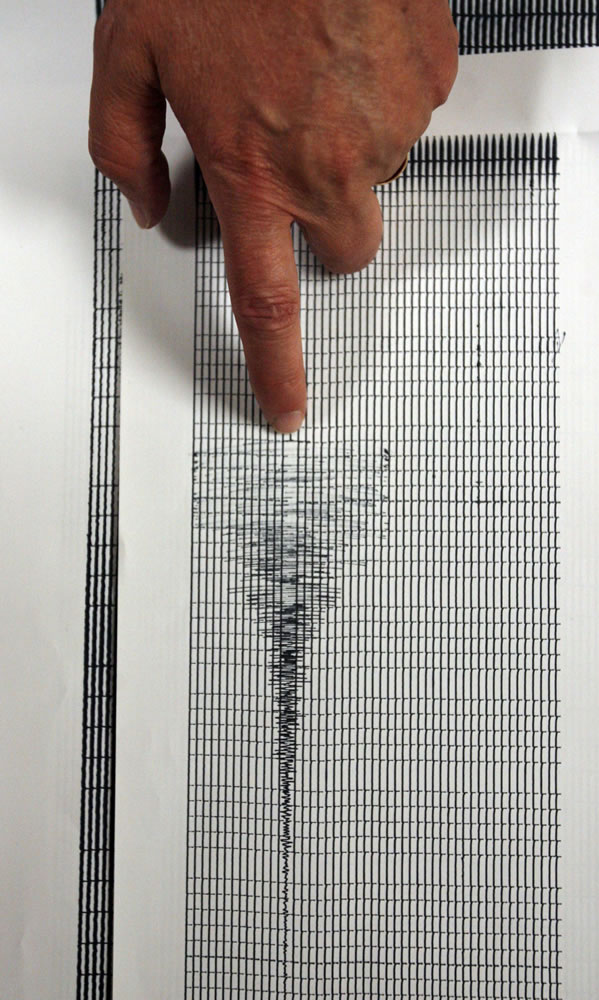 Relu Burlacu, station manager for University of Utah Seismograph Center, points  on Aug. 7, 2007, to an early morning seismic event recorded Aug. 6, measuring 3.9, which could have been an earthquake or the mine collapse itself that recently happened in Huntington, Utah. Scientists believe the seismic waves in the area of the Crandall Canyon mine were &quot;the signature of the collapse and that the collapse was not caused by an earthquake,&quot; said James W. Dewey, a seismologist at the National Earthquake Information Center.