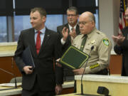 Neil Burkhardt, left, who tackled a shooter at the Vancouver Veterans Affairs center on Feb. 4, 2014, receives the county&#039;s Citizen Service medal from then-Sheriff Garry Lucas on Dec. 9, 2014.