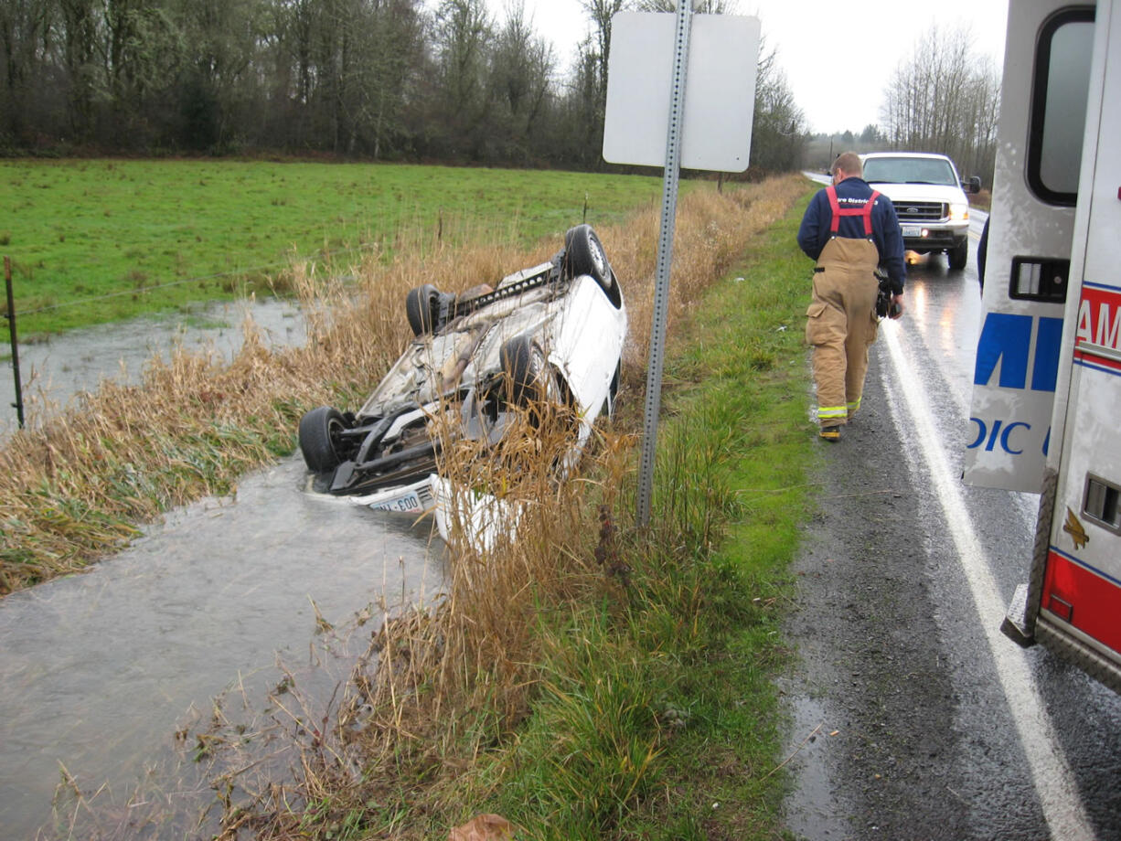 A white sedan rolled over into a ditch on Northeast Ward Road Monday morning, and the cabin started to fill with water.