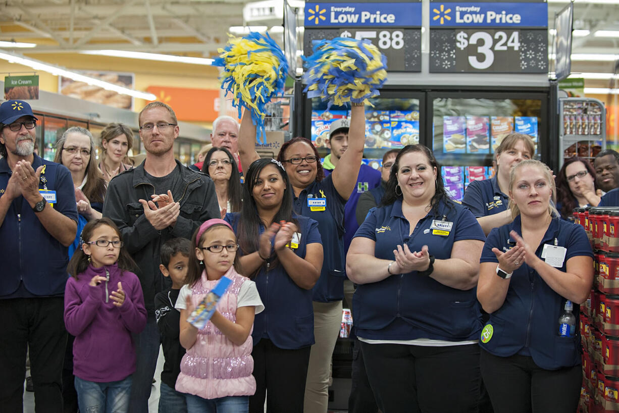 Wal-Mart employees join shoppers and community leaders in celebrating the opening of the Orchards store in September.