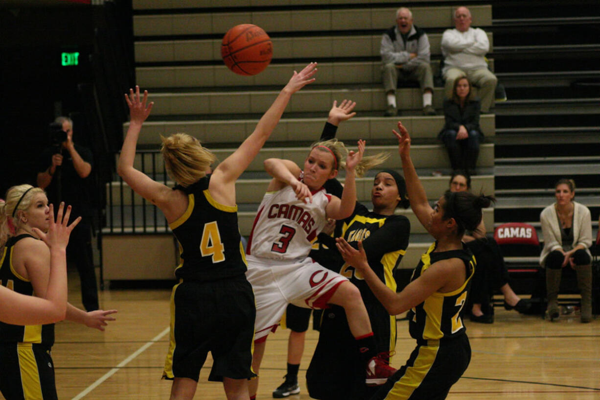 Camas High School senior McKenna Jackson tricks three defenders and passes the ball to an open teammate.