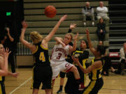 Camas High School senior McKenna Jackson tricks three defenders and passes the ball to an open teammate.