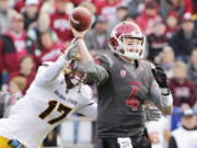 Washington State quarterback Luke Falk (4) passes as he is hit by Arizona State linebacker Ismael Murphy-Richardson (17) during the first half of an NCAA college football game, Saturday, Nov. 7, 2015, in Pullman, Wash.