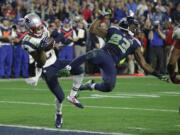 FILE - In this Feb. 1, 2015, file photo, New England Patriots cornerback Malcolm Butler (21) intercepts a pass intended for Seattle Seahawks wide receiver Ricardo Lockette during the NFL Super Bowl XLIX football game in Glendale, Ariz.