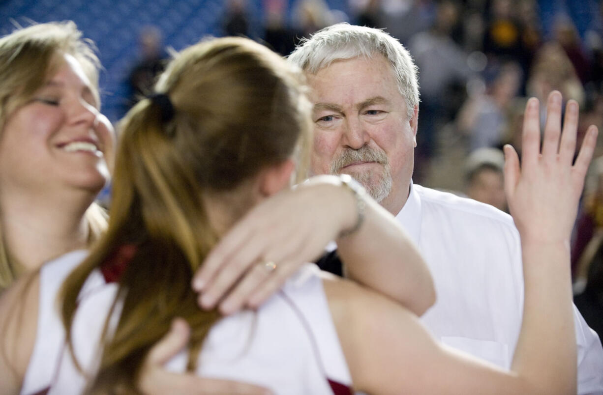 Coach Al Aldridge smiles as his Prairie High players celebrate their 3A state championship after defeating Franklin 54-44 in March.