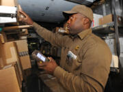 Keith Short, a UPS Service provider and driver, uses a DIAD (Delivery Information Acquisition Device), a hand-held computer, which gives him the delivery information for each package, in Baltimore.