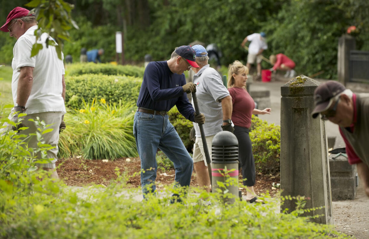 A crew of retirees manage garden space along the Waterfront Renaissance Trail near the Water Resources Education Center on Monday.