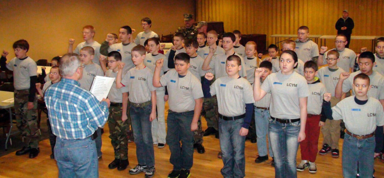 Riveridge: Lewis &amp; Clark Young Marines Recruit Platoon 33013 stand at attention Jan. 5 at the Vancouver Elks Lodge as Vancouver City Councilor Larry Smith leads them in the Young Marine Obligation oath.