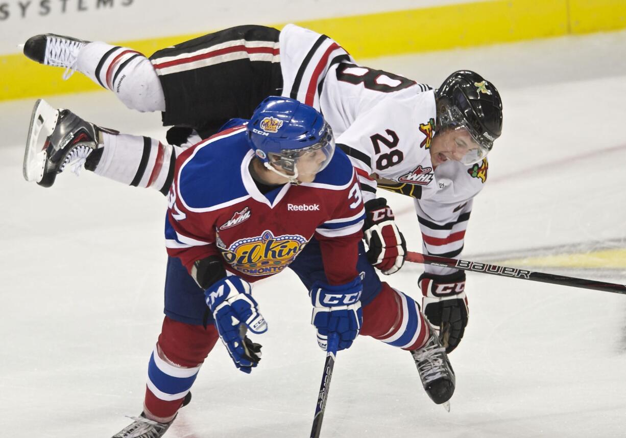 Portland's Brendan Leipsic takes a tumble over Edmonton defenseman Dysin Mayo in the first period at the Rose Garden on Friday.