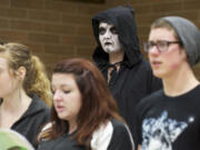 Prairie High School senior Elizabeth Perry, 18, stands in her choir class after she &quot;died&quot; in a car crash during the Every 15 Minutes program. Students were removed from class, put on a black robe and face paint and returned, silently, to class.