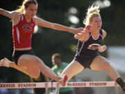 Jordan Davis, left, of Camas High School, and Madison Lanford of Skyview High School, compete in the girl's 300 meter hurdles at the 4A District Track and Field meet Wednesday May 8, 2013 in Vancouver, Washington at McKenzie Stadium. Lanford won with a time of 45.73.