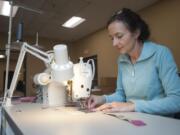 Designer Lisa Tice sews felt pieces onto a bag for an iPad at Last U.S. Bag Company. In addition to its own lines, the Vancouver company provides custom prototyping and manufacturing.