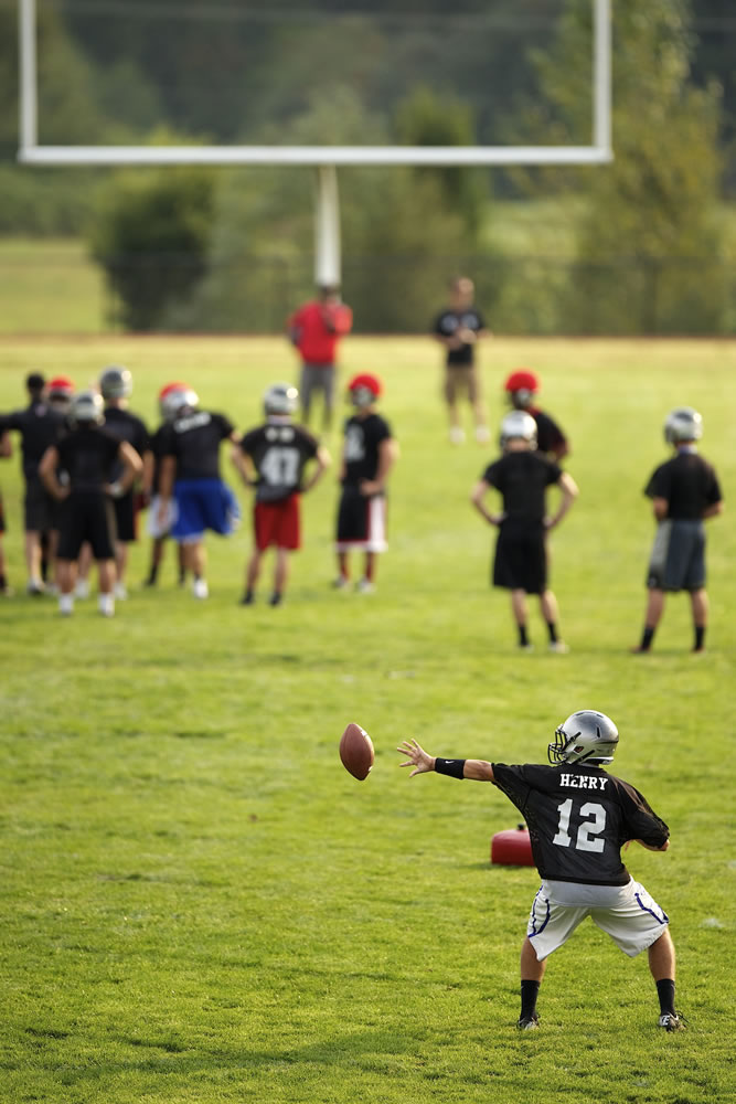 Nolan Henry, a junior quarterback playing for the Union High School football team, practices runs through drills during Thursday's practice.