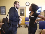 Vitaliy Stepanyuk, a student at Clark College, talks with Cetara Davis, also a student at Clark College, on Tuesday, about differences of opinion after a forum discussing a Camas couple who hung an empty chair symbolizing President Barrack Obama from a tree in their yard.