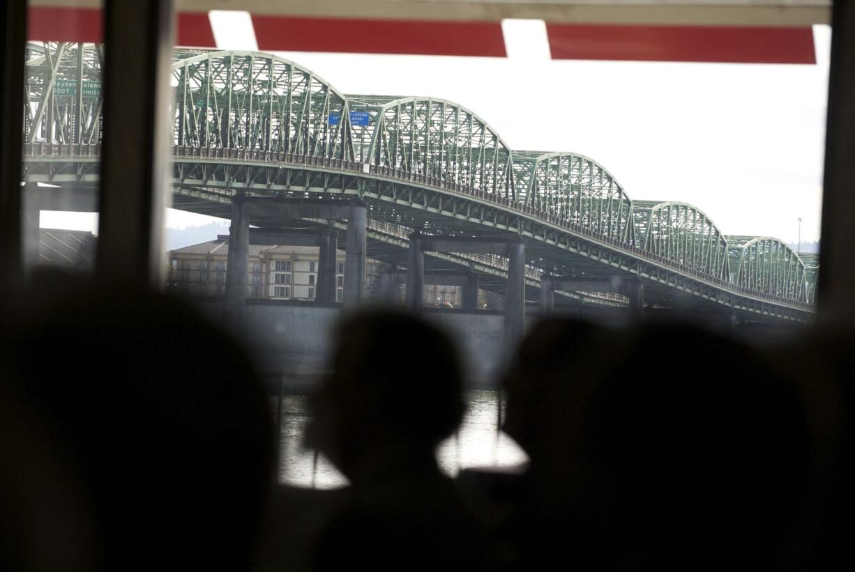 With the Interstate Bridge as a backdrop, opponents of the CRC hold a rally against the project March 29 at the Red Lion Hotel at the Quay.