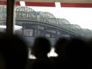 With the Interstate Bridge as a backdrop, opponents of the CRC hold a rally against the project March 29 at the Red Lion Hotel at the Quay.