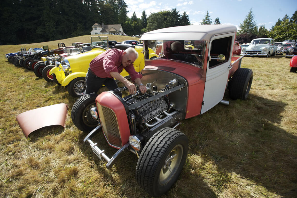 Slo Poks member Bruce &quot;Butch&quot; Cassidy prepares to add coolant to his 1932 Ford pickup at the club's 60th anniversary party in Felida on Sunday.