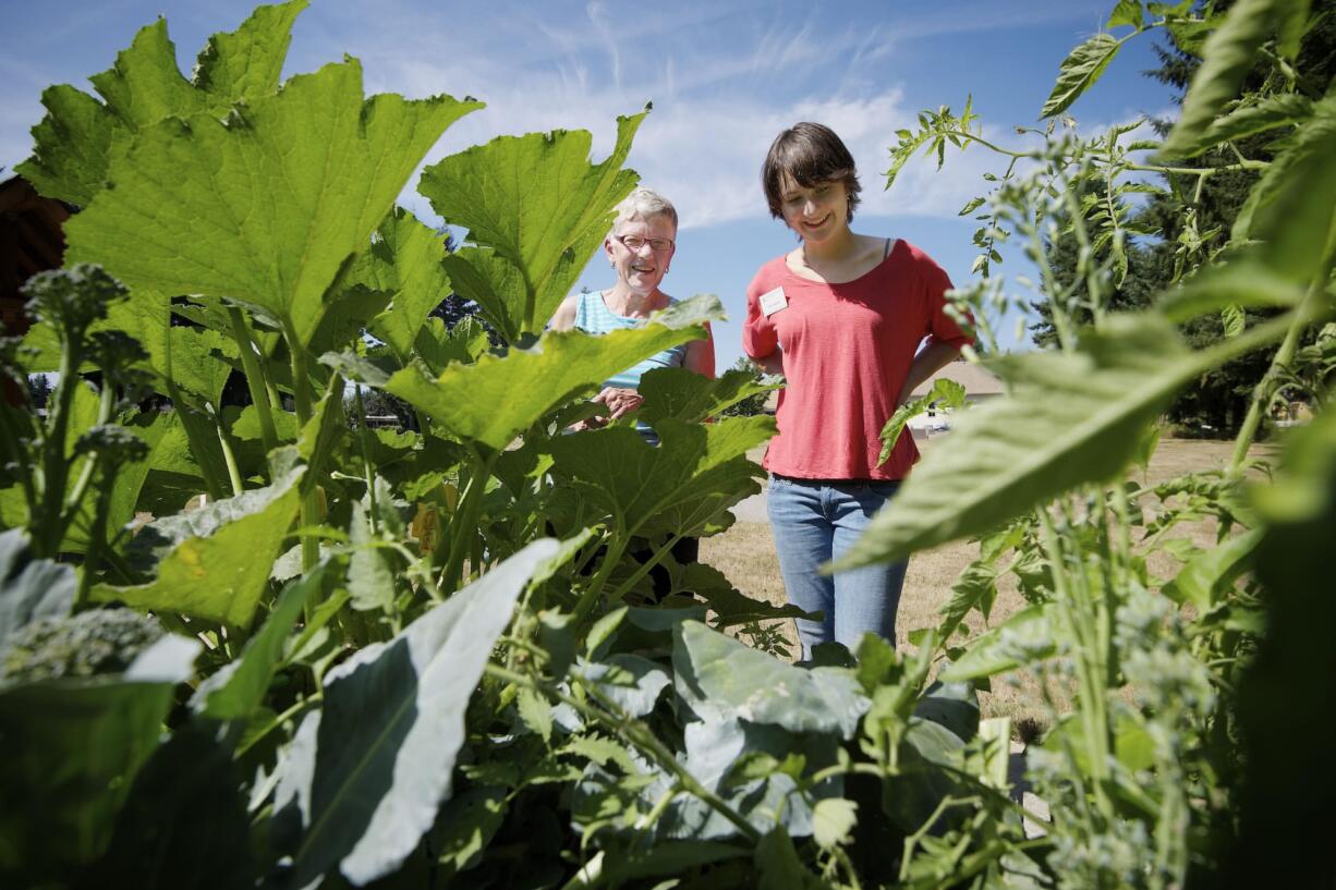 Bethel church member Geni Hammer, left, and master gardener and gardening mentor Eve Hanlin admire the richness of the Bethel Community Garden.