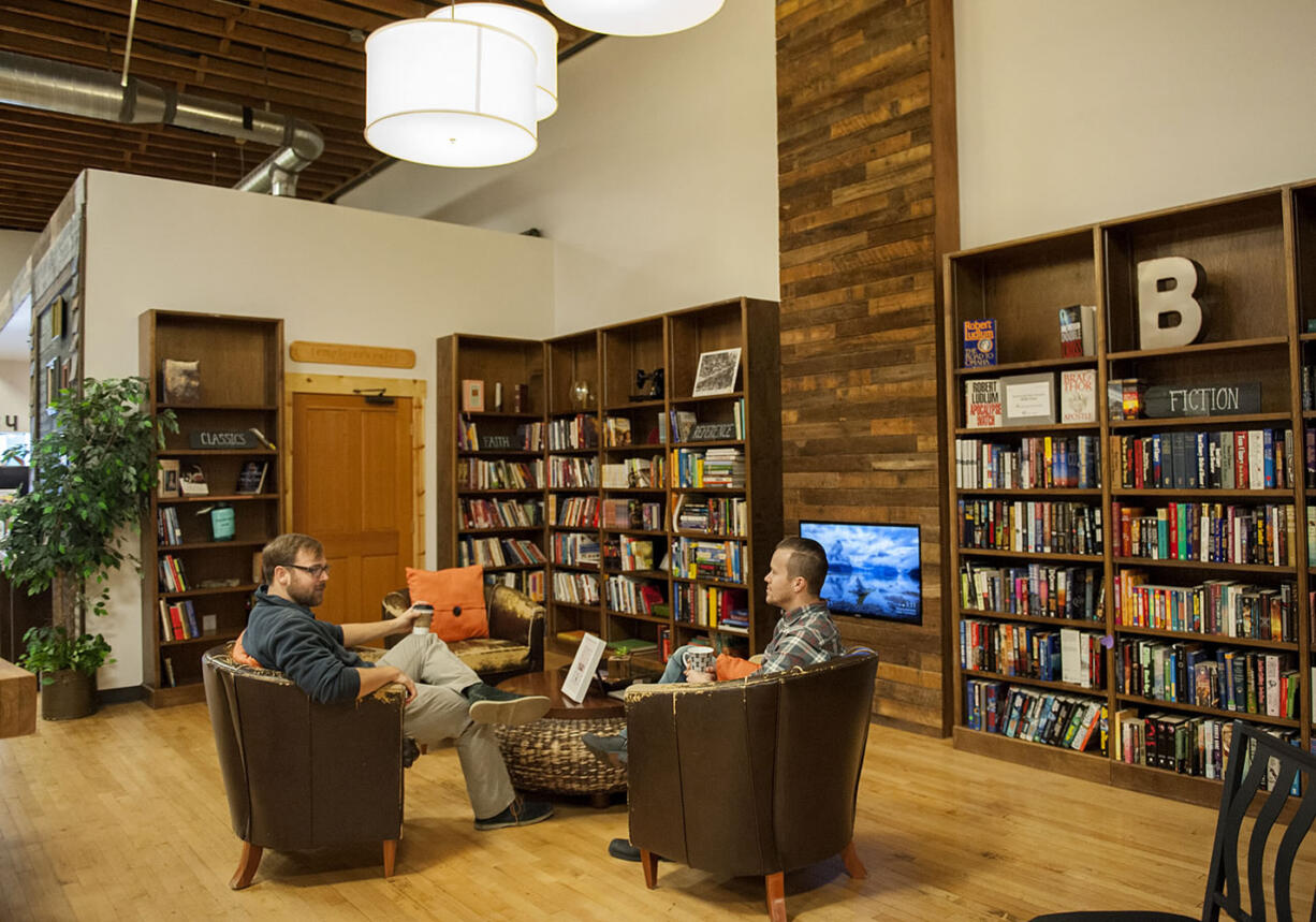 Joe Clark of Vancouver, left, talks with general manager Peter Johnsen at Boomerang, the downtown Vancouver re-sale store where each purchase sees half of its proceeds go to a Southwest Washington-based nonprofit.