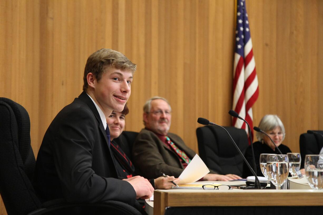 Caleb Bischoff, the student representative on the Washougal City Council, smiles at an audience member on Monday night.