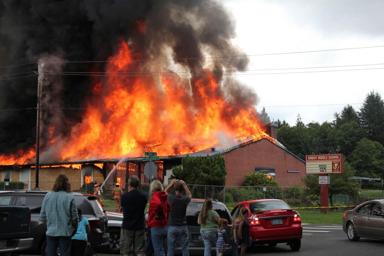 The former Amboy Middle School goes up in flames Saturday. The fire lowered the school district's costs for razing the building and helped train volunteer firefighters.