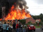 The former Amboy Middle School goes up in flames Saturday. The fire lowered the school district's costs for razing the building and helped train volunteer firefighters.