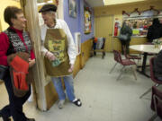 Chris Soltisiak, a Share House volunteer for more than 20 years, talks to Gary Anderson in the dining room on Friday.