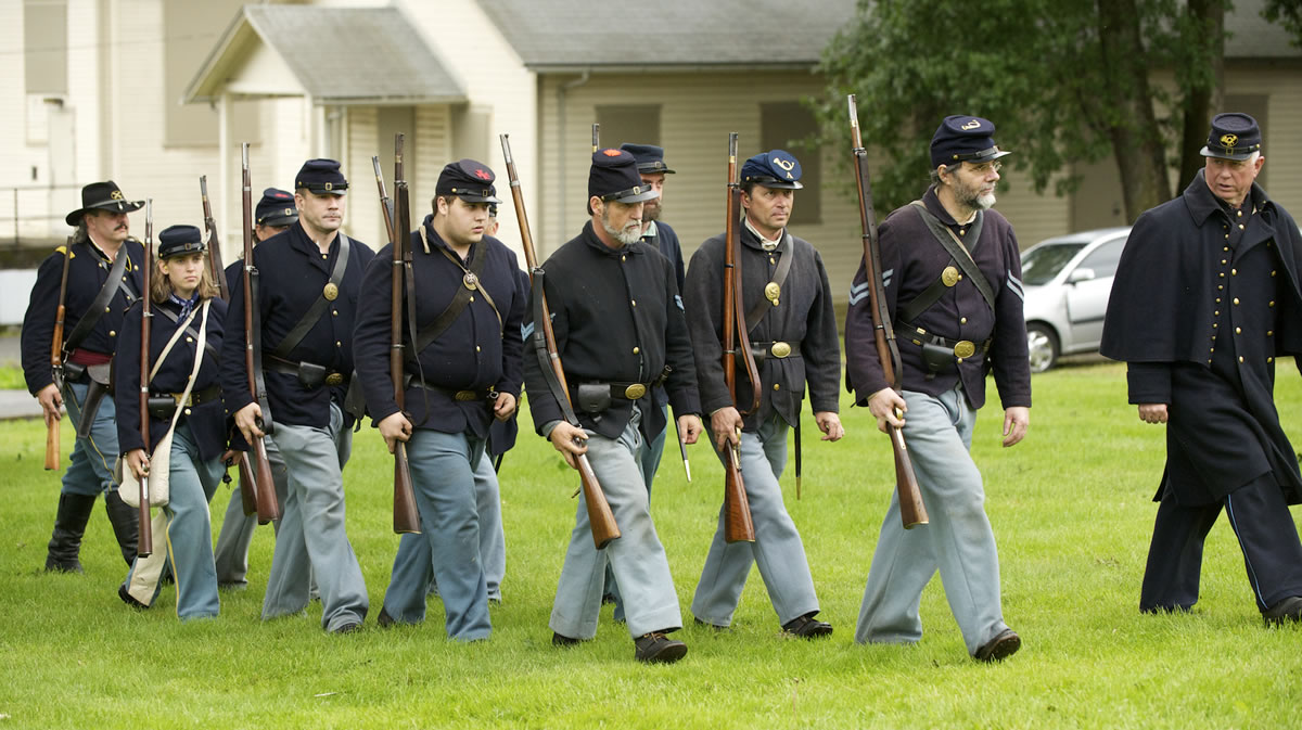 Under the scrutiny of Mitch Rice, far right, Gregg Moore leads 1st Oregon volunteers on a Memorial Day marching drill at Vancouver Barracks.