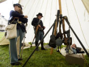 1st Oregon Volunteer Infantry re-enactors make themselves at home in a Sibley tent during a soldiers' bivouac at Vancouver Barracks on Memorial Day.